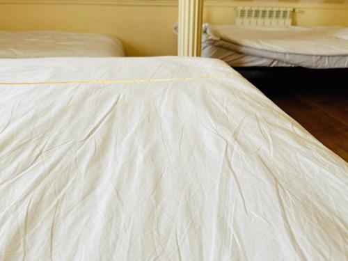 a close up of a white bed in a room at SD Hotel in Yerevan