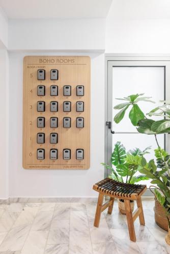 a living room with a wooden abacus on the wall at Boho Rooms in Thessaloniki