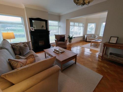 a living room with a couch and a fireplace at Luxury Lodges in Doolin Village with Hot Tubs in Doolin
