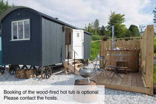 a tiny house sitting on a wooden deck at West Coast Hideaways in Nedd
