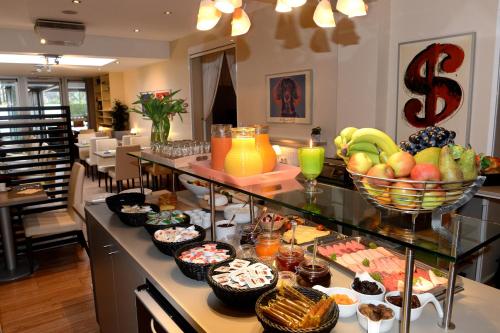 a buffet of food on a counter in a room at Hotel Vijfwegen in Roeselare
