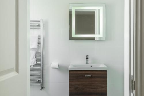 a bathroom with a sink and a mirror at Carlton Lodge, Two bedroom apartment with parking space in Broadstairs