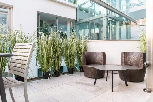 two chairs and a table in front of a building at Artist House in Merano