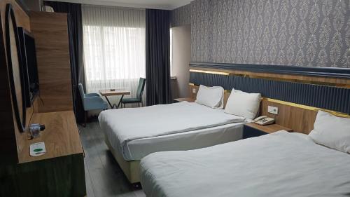 Ένα ή περισσότερα κρεβάτια σε δωμάτιο στο Madi Hotel Ankara