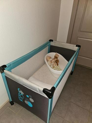 a baby crib with a bowl of food in it at La Distillerie 1881 in Aillevillers-et-Lyaumont