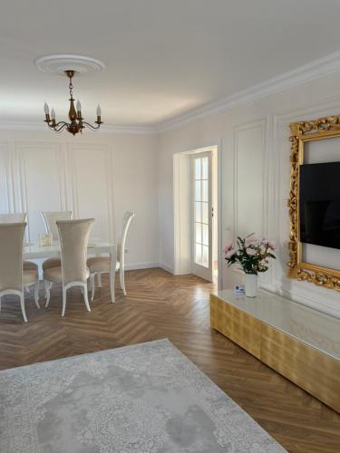 a dining room with a table and a mirror at The SUN VILLA in Preajba