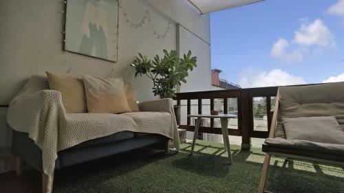 a living room with a couch and a table on a balcony at 木Box田妍山色 in Jiaoxi
