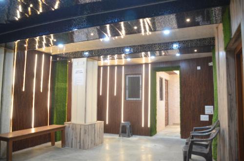 a room with a wooden wall with a bench and lights at ViratHomestay in Varanasi
