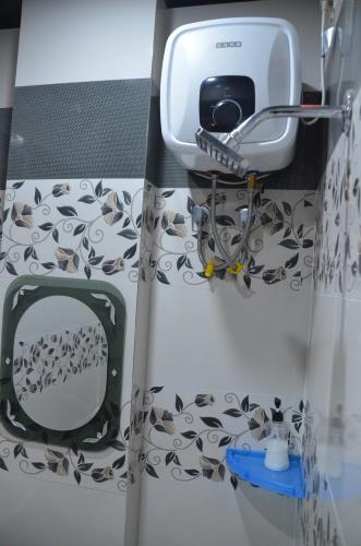 a bathroom with a hair dryer and a mirror at ViratHomestay in Varanasi