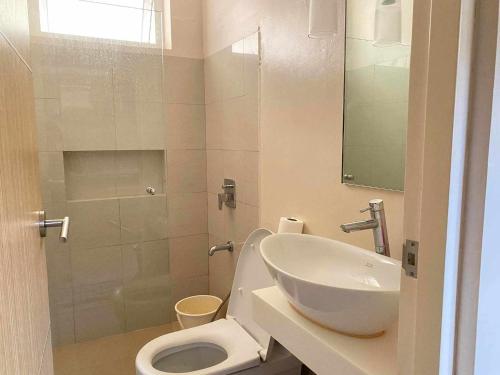 a bathroom with a toilet and a sink and a shower at Miranda A 616 - Cozy Retreat at Pico De Loro Beach, Nasugbu Batangas in Nasugbu