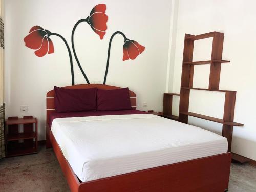 a bedroom with a bed with two lamps on it at Shell Abay in Arugam Bay