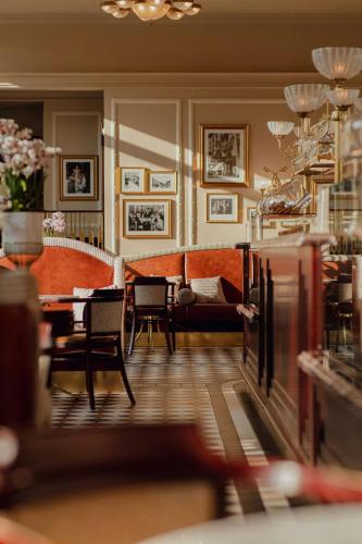 a living room with a couch and a table and chairs at Hotel Bristol, A Luxury Collection Hotel, Warsaw in Warsaw