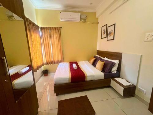 a small bedroom with a bed in a room at KK SERVICE APARTMENTS in Vellore