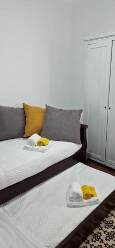 a bedroom with a bed with towels on it at Casa do Bairro - O seu refúgio in Ponta Delgada