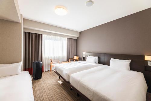 Postel nebo postele na pokoji v ubytování Hotel Sunroute Plaza Shinjuku