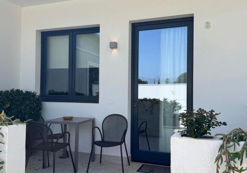 a patio with a table and chairs and a door at Tenuta San Marco in Noto