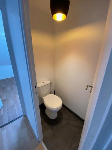 a bathroom with a toilet and a light on the ceiling at appartement hyper centre ville in Arras