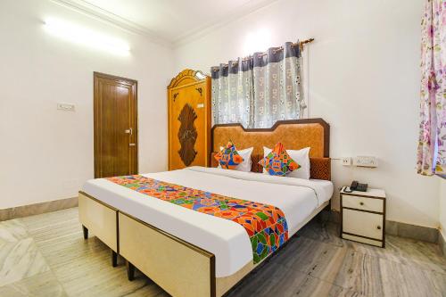 a bedroom with a large bed in a room at FabExpress Astoria House - Near Central Park in kolkata