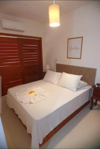 a bedroom with a bed with a towel on it at Suíte Sol do Gostoso in São Miguel do Gostoso