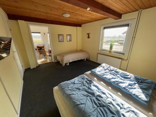 a bedroom with a bed and a window at Marskferie Tønder in Tønder