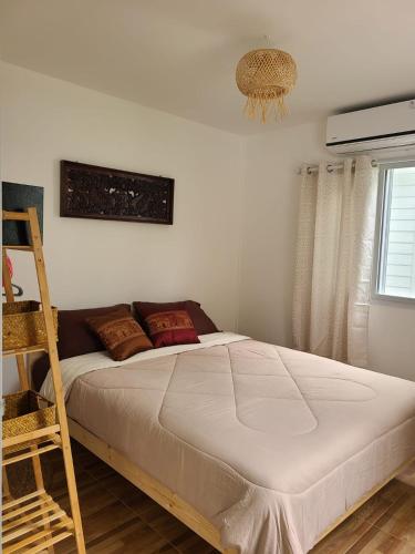 a bedroom with a bed with a ladder and a window at Leelawadee Bungalow and Restaurant in Mae Nam