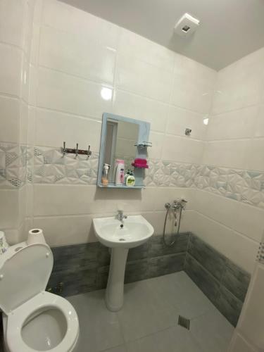 a bathroom with a toilet and a sink at Black Sea Pearl in Makhinjauri
