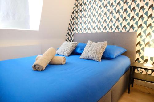 a blue bed with two pillows on top of it at Your Home Loos 2 - Proche Lille in Loos