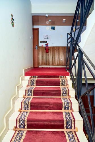 a staircase in a building with red carpet at CONGRESS HOTEL Yaoundé in Yaoundé
