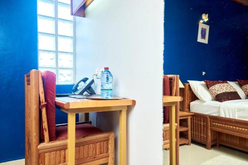 a room with a table with a bottle of water on it at CONGRESS HOTEL Yaoundé in Yaoundé