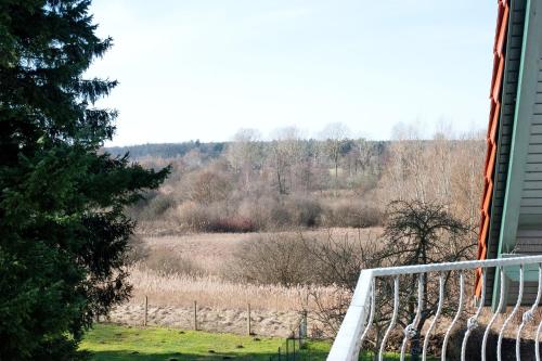 a balcony with a view of a field and trees at Süd-Balkon an der schönen Peene in Demmin