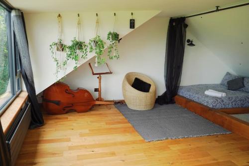 a room with a bed and a violin in a room at The Ridge London - Luxury Designer Villa with hot tub and sauna, Bexley borough of London in London