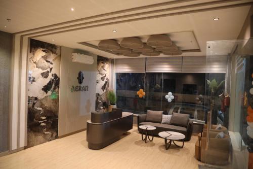 a living room with a couch and a table at The Aeran Foods & Hospitality in Chhala