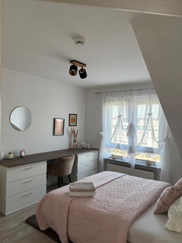 a bedroom with a bed and a desk and a window at ERBEX to in Dietzenbach
