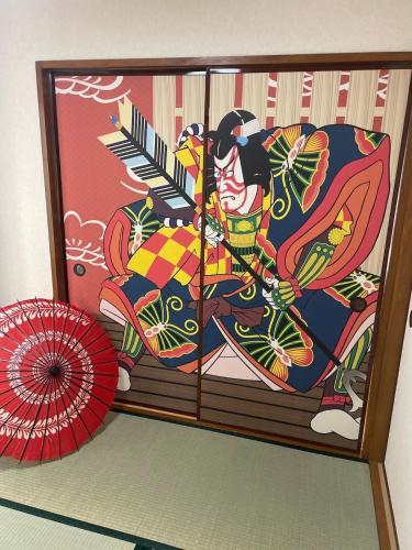 a painting of a person with an umbrella at 1階 2025年3月オープン 小岩徒歩15分 収容4人 成田羽田からバス直通 in Tokyo
