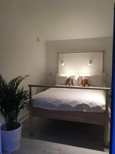 a bedroom with a bed with two teddy bears on it at Dunmore East Glamping Cabins in Dunmore East