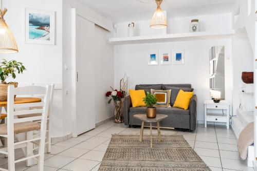 a living room with a couch and a table at Ziv Boutique Apartments Town Square II in Lefkada Town