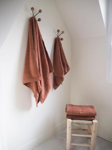 La salle de bains est pourvue de 3 serviettes accrochées au mur. dans l'établissement Studio Wabi Sabi Graslin, à Nantes