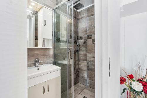 a bathroom with a shower and a sink at Ziv Boutique Apartments Town Square II in Lefkada Town