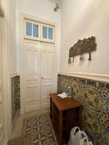 a room with a white door and a wooden table at Mirador de la médina in Tunis