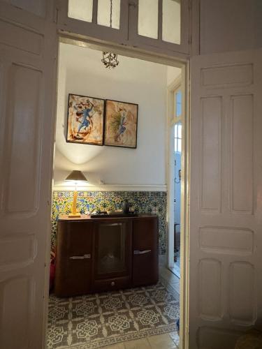 an open door to a room with a table and a lamp at Mirador de la médina in Tunis