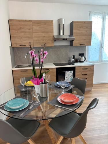 a dining room table with chairs and a table with plates at La perla del Lago d Orta in Omegna
