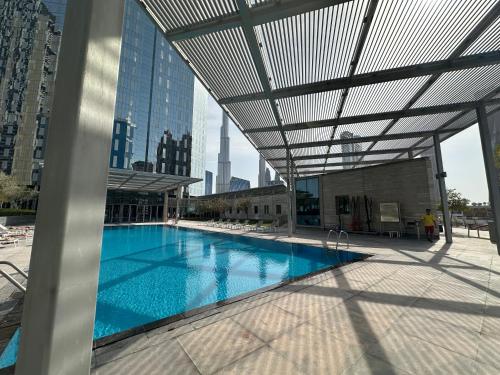 a large swimming pool in a building with a roof at Central Park Towers Royal suite DIFC Downtown in Dubai