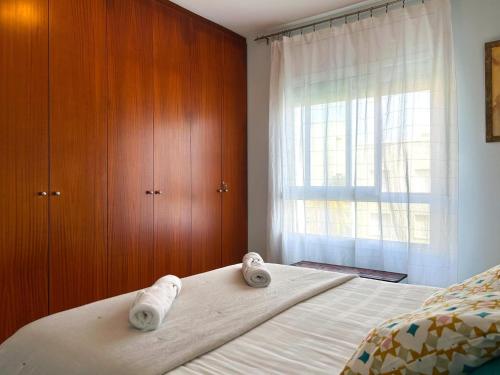 a bedroom with a bed with towels on it at Apartment Rivel in Cubelles