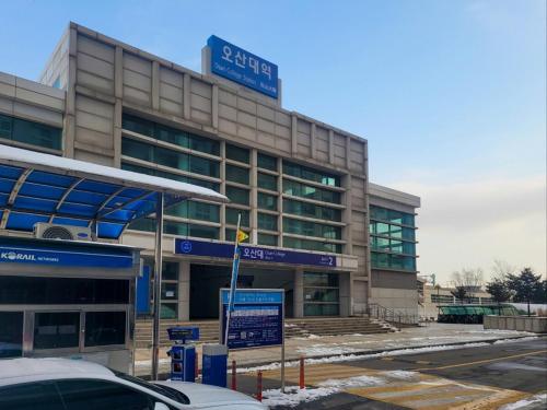 a building with a street sign in front of it at Won stay in Osan