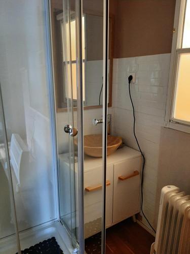 a shower with a glass door in a bathroom at Au petit coin tranquille in Saint-Gobert