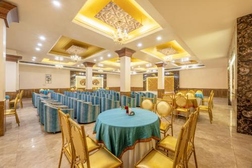 a banquet hall with blue tables and chairs at Pink Pearl Hotel By Chokhi Dhani in Jaipur