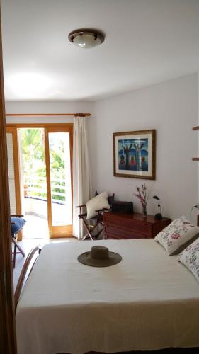 a bedroom with a bed with a hat on it at Beach Apartment Minerva in Port d'Alcudia