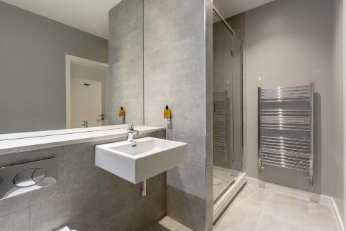 a bathroom with a sink and a shower at Destiny Scotland Apartments at Canning Street Lane in Edinburgh