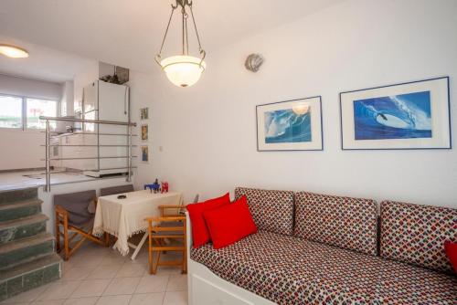 a living room with a couch and a table at Big blue pefkohori in Pefkohori