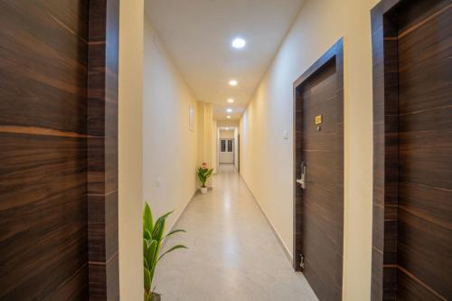 a hallway of a house with a door and a plant at VR PARADISE Inn in Kelambākkam